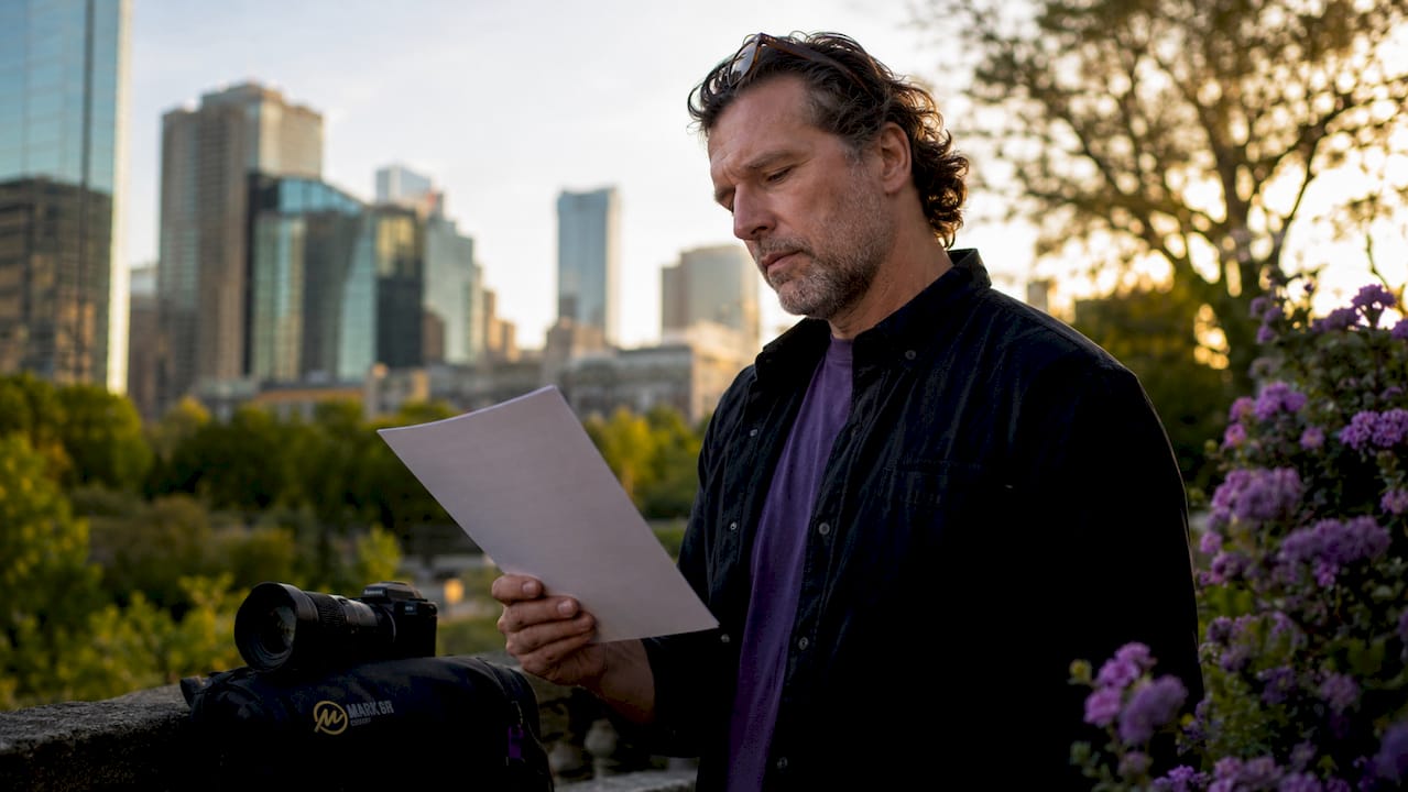 Photographer holding signed license contract in studio