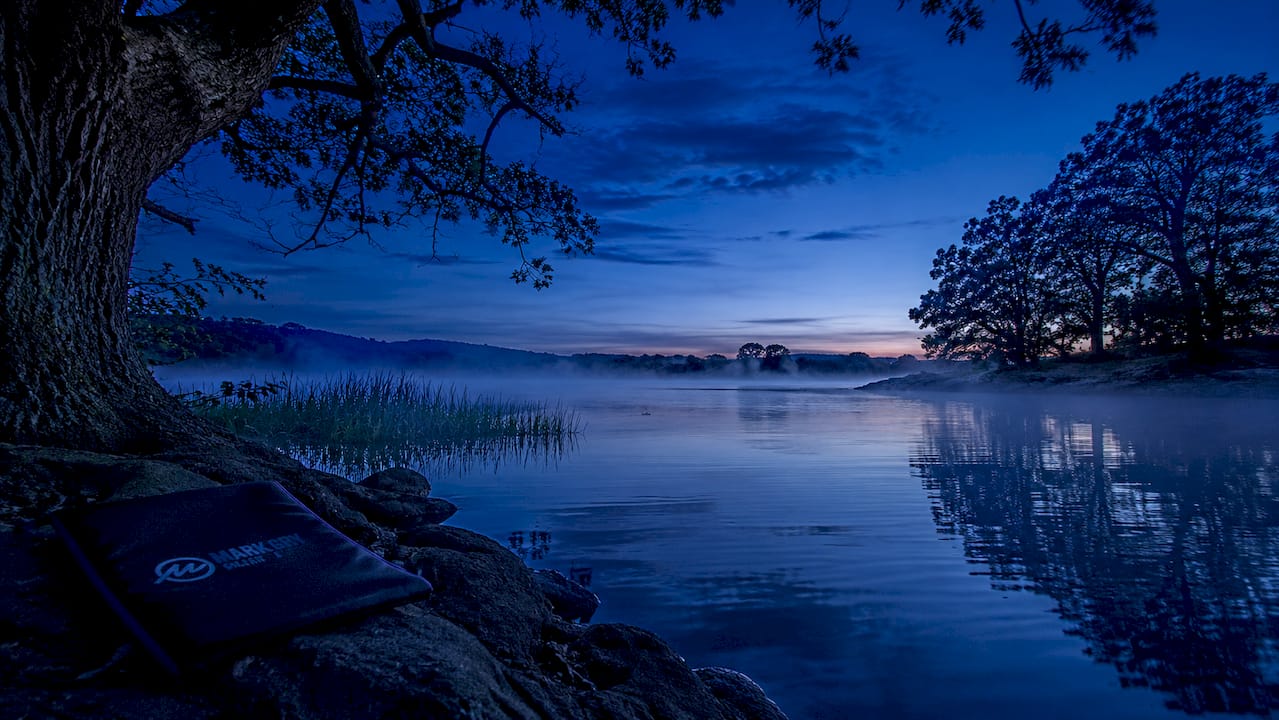 Serene lakeside landscape at blue hour with mist
