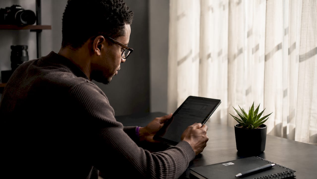Photographer reviewing royalty reports on tablet