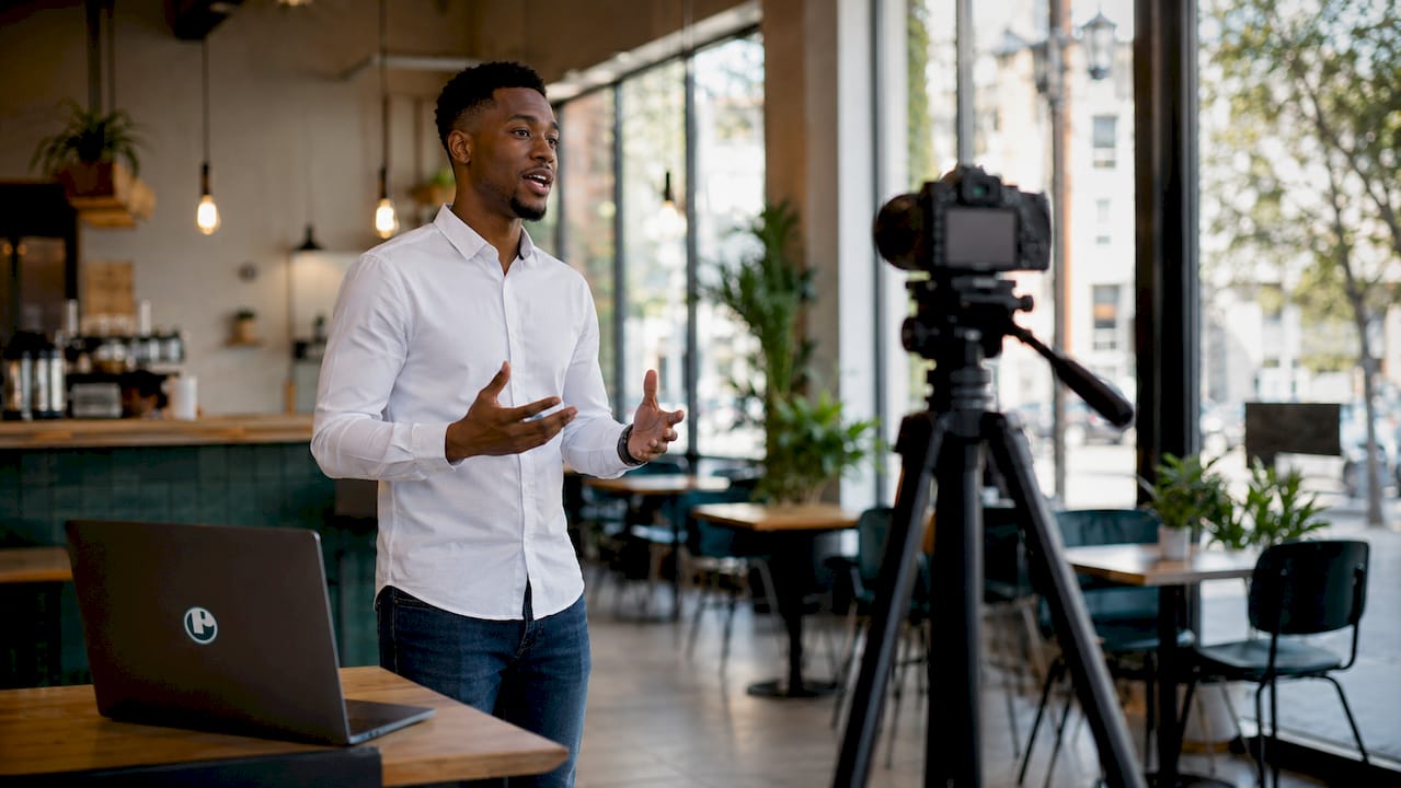 Presenter rehearsing script at home office setup