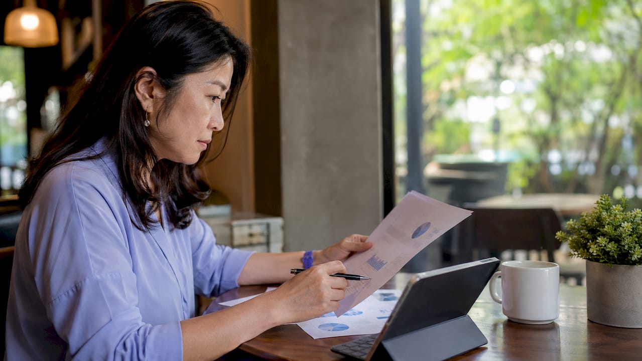 Woman analyzing financial metrics in meeting room