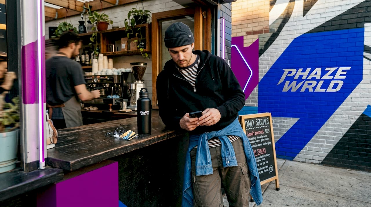 Streetwear enthusiast layering outfits in café