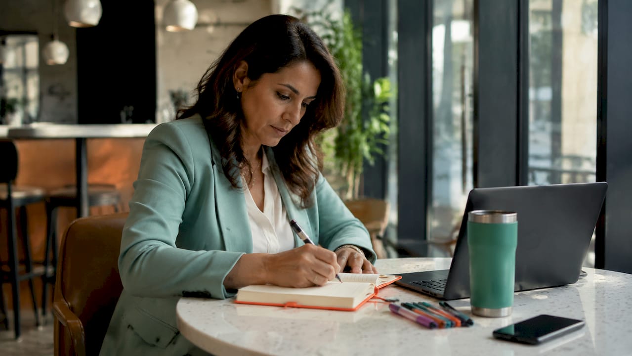 Executive education student taking notes in modern classroom