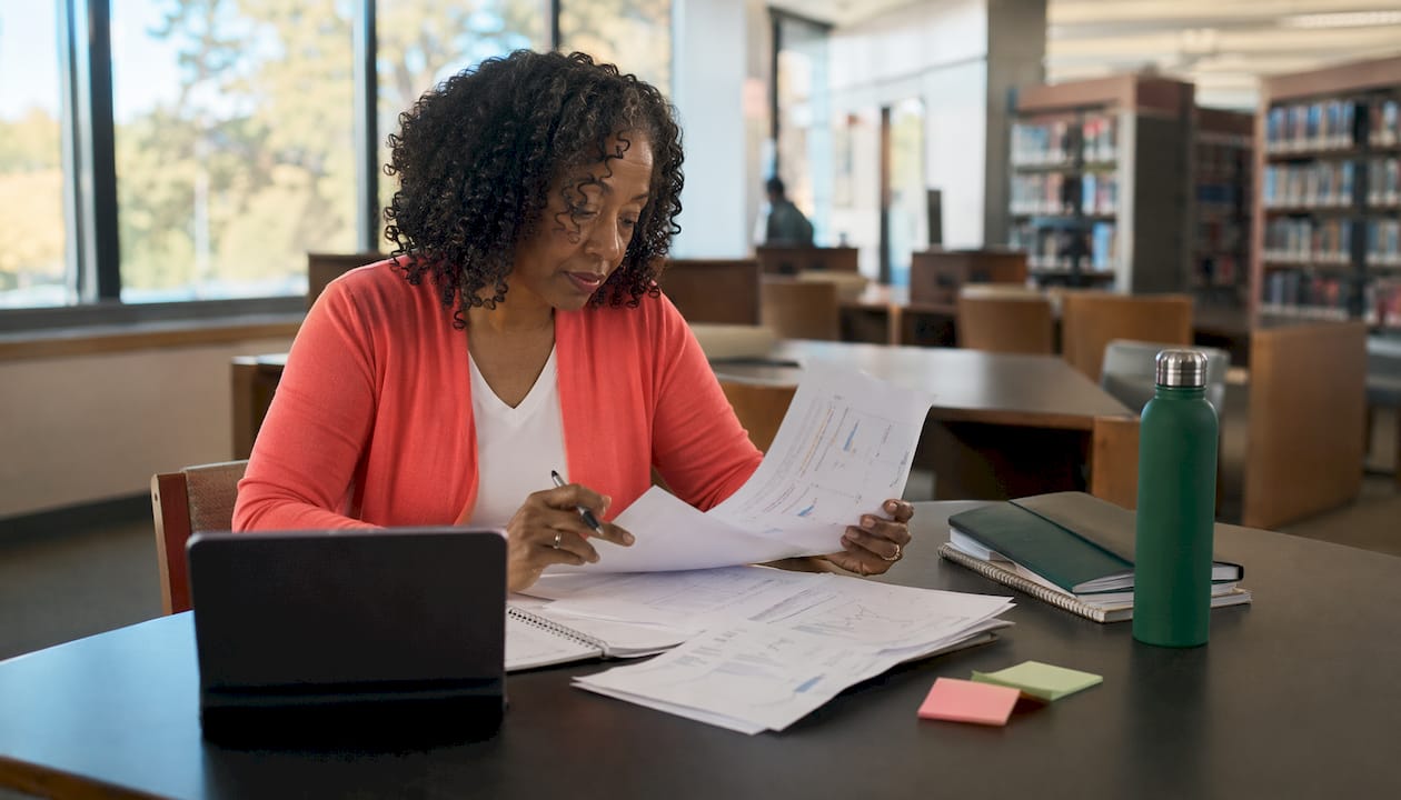 Woman reviewing exam simulation feedback in study room