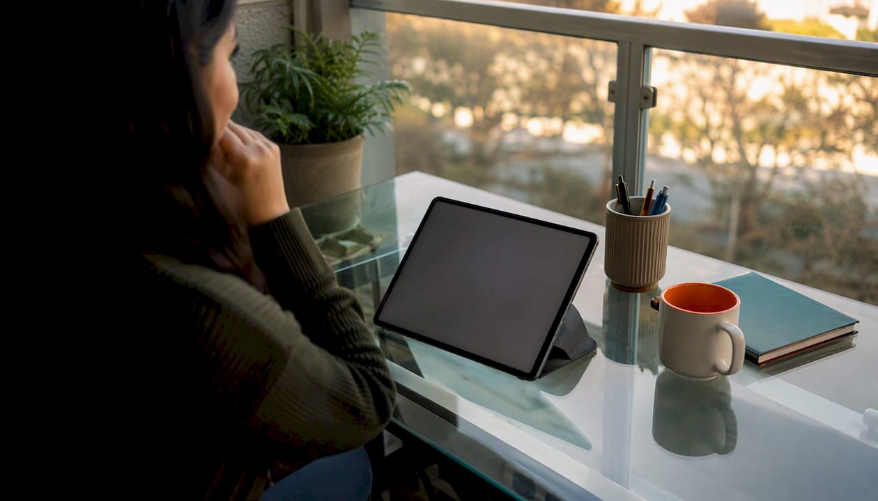 Tablet in study with progress dashboard blurred