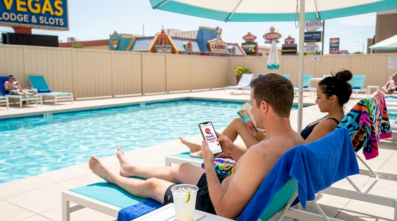 Guests relax at modest pool off Strip