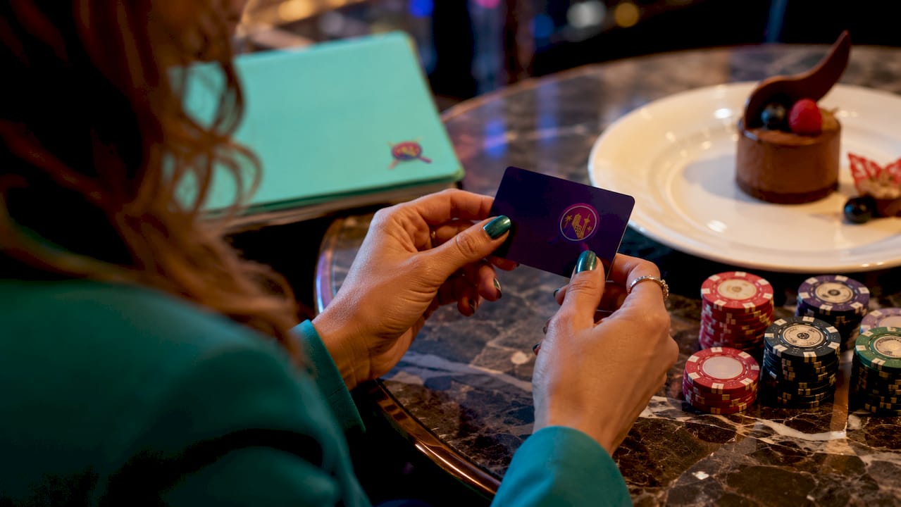 Hands holding casino loyalty rewards card