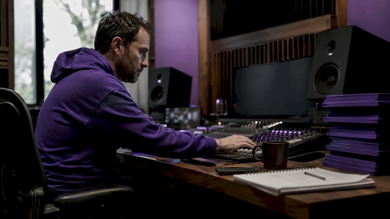 Audio engineer in studio reviewing audio workstation