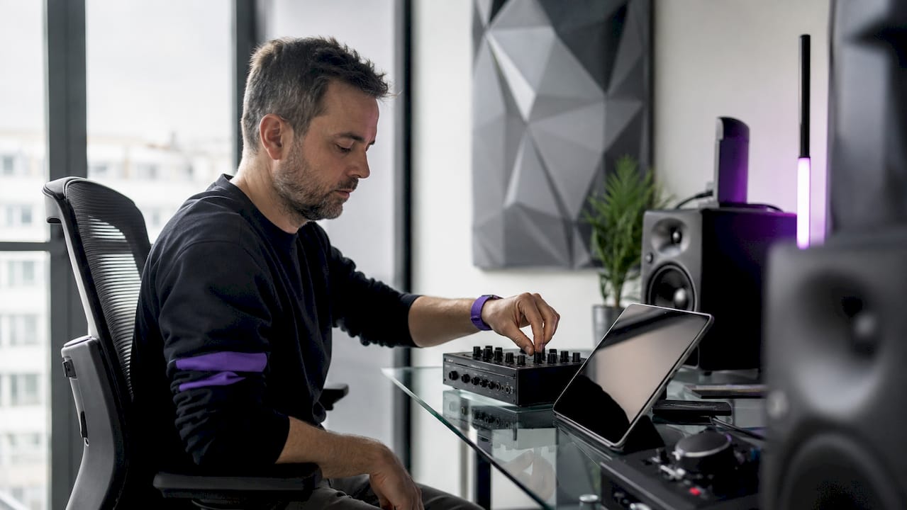 Audio engineer working with DSP hardware and notes