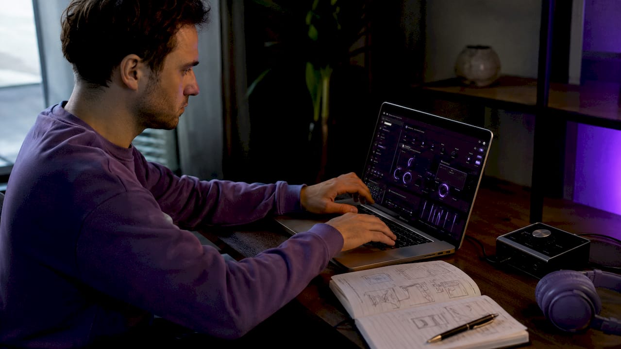 Hands adjusting ambient effects on laptop audio software