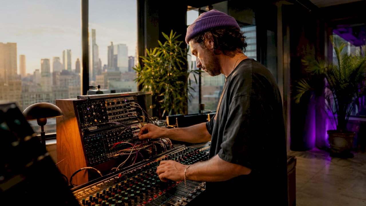 Ambient music producer working at home studio desk
