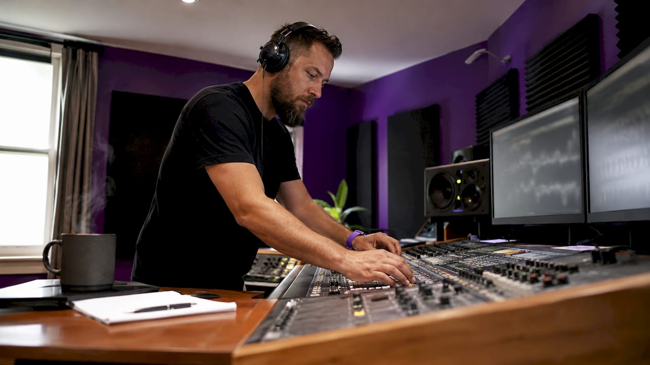 Audio engineer working at home studio desk