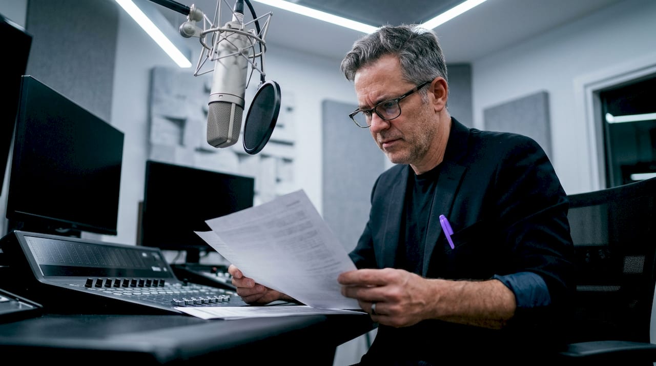 Audio engineer reviewing printed professional standards