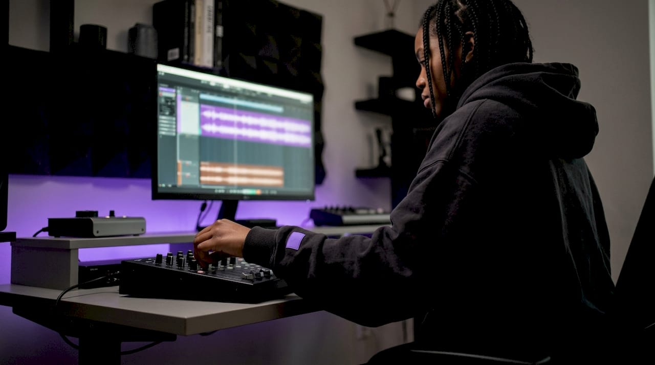 Producer adjusting stereo imaging in studio