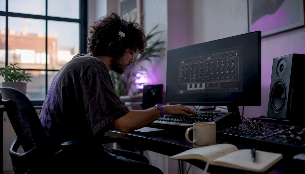 Music producer adjusting lo-fi plugins in home studio