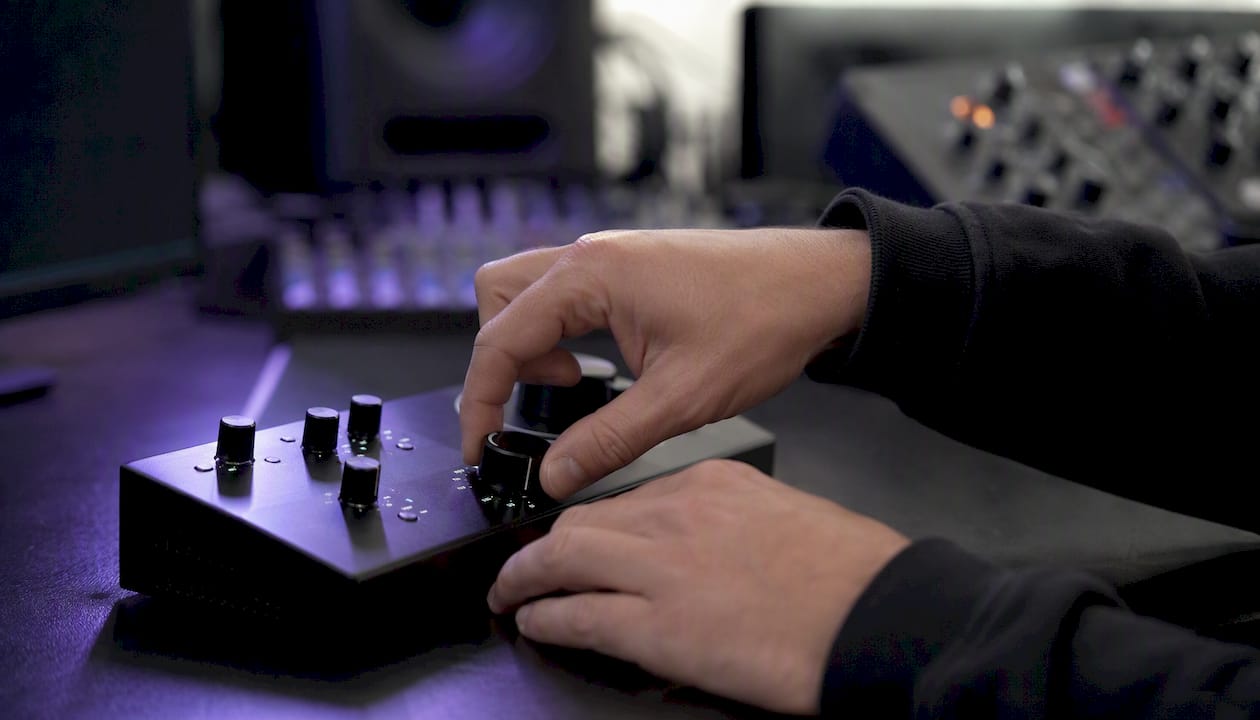 Hands adjusting hardware limiter knob close-up