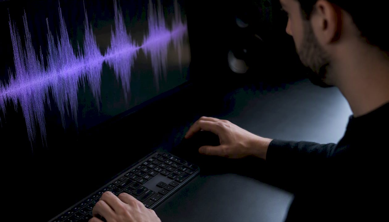 Glowing audio waveform on dark screen