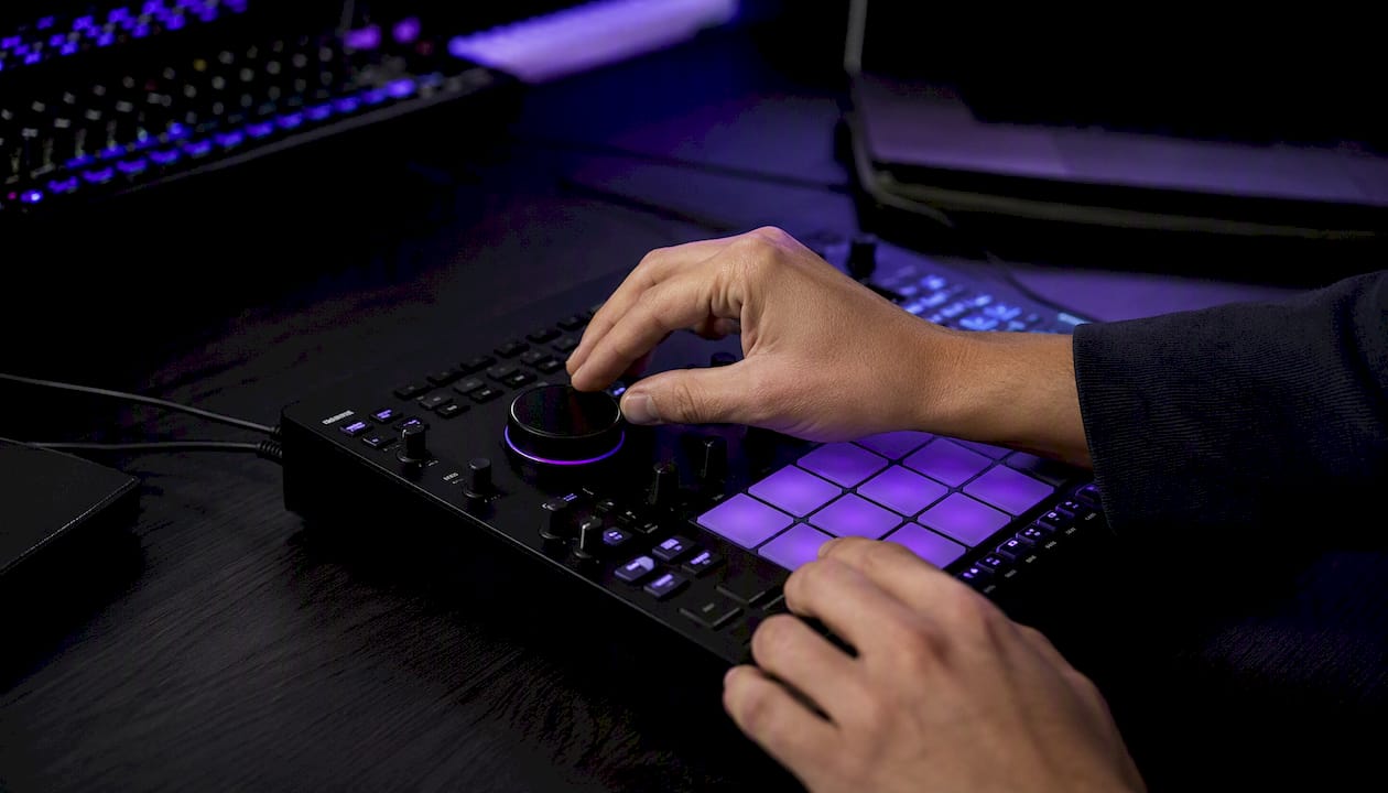 Hands adjusting MIDI controller tempo dial
