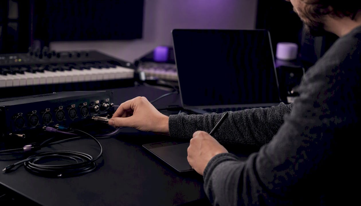 Hands working on MIDI audio coding in studio
