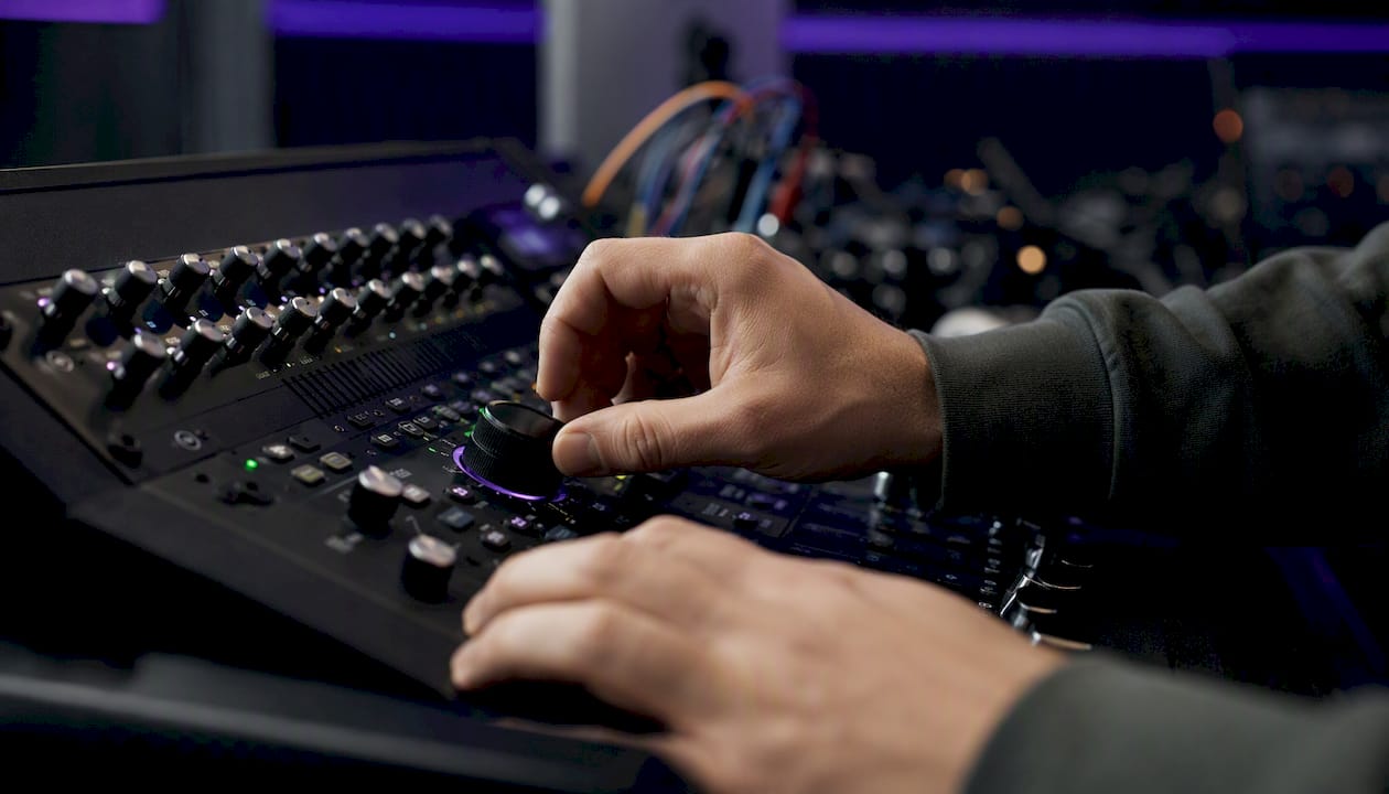Hands adjusting buffer size control in studio