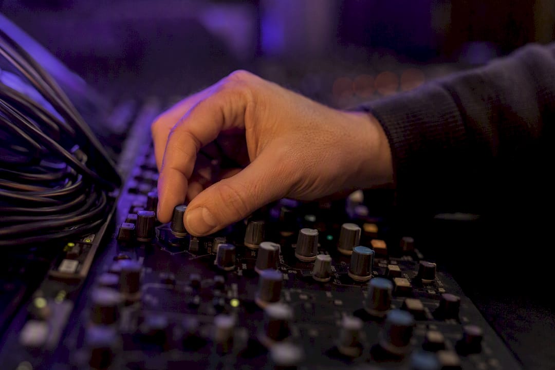 Hand adjusting high-pass filter knob on reverb return