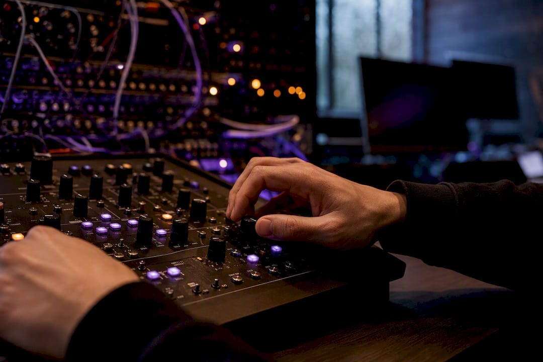 Hands adjusting wet/dry mix knob on audio console