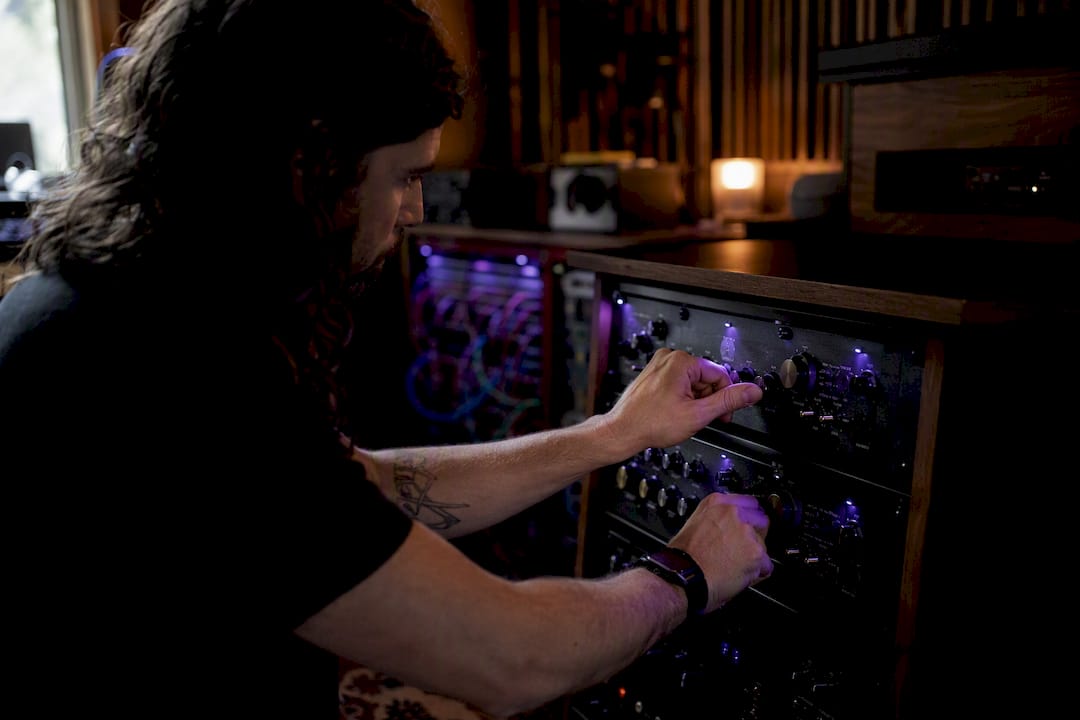 Hands tuning analog audio crossover knobs