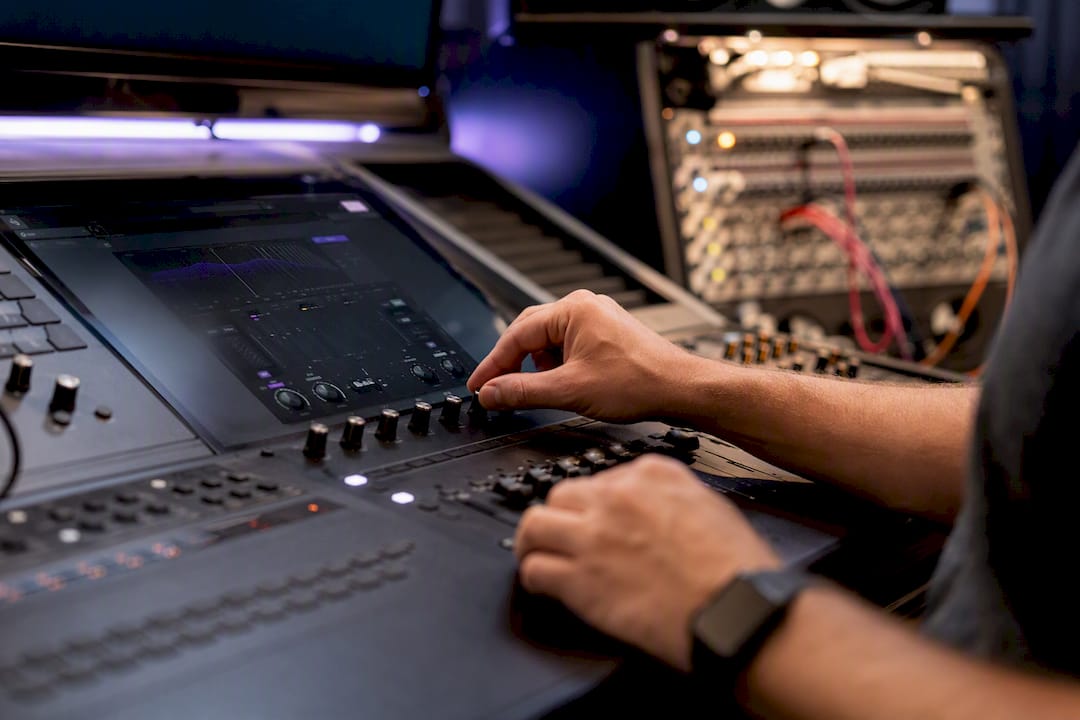 Hands adjusting de-esser and compressor controls