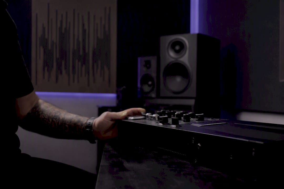 Hand holding equipment in dim lit audio lab