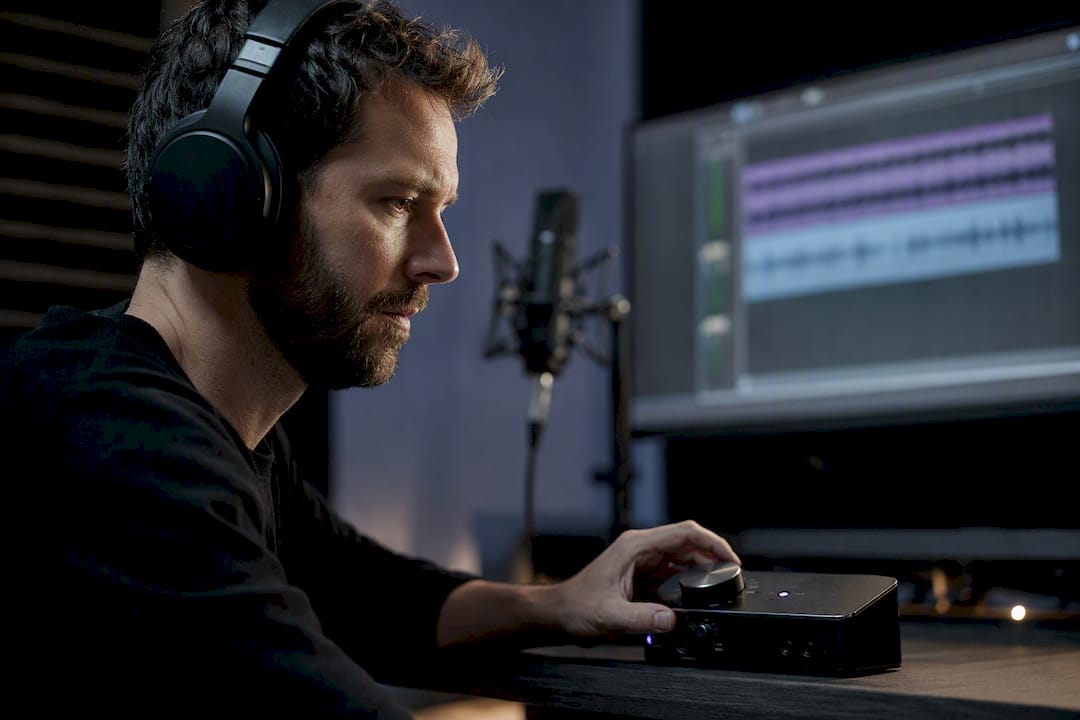 Engineer monitoring audio through studio interface