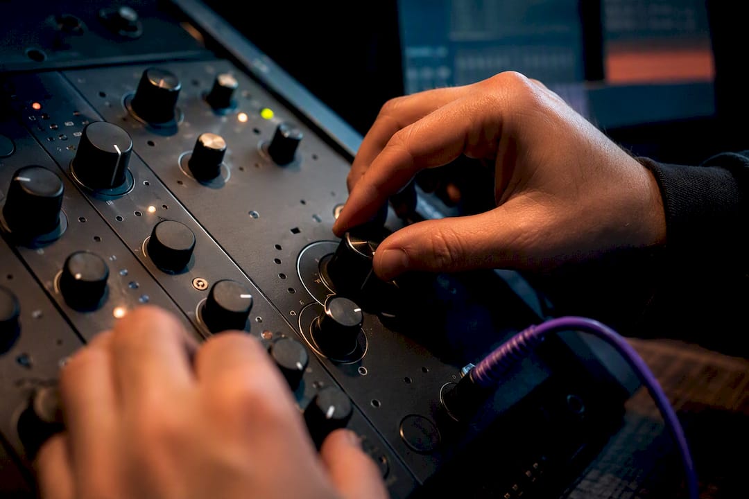 Engineer adjusting EQ and compressor controls