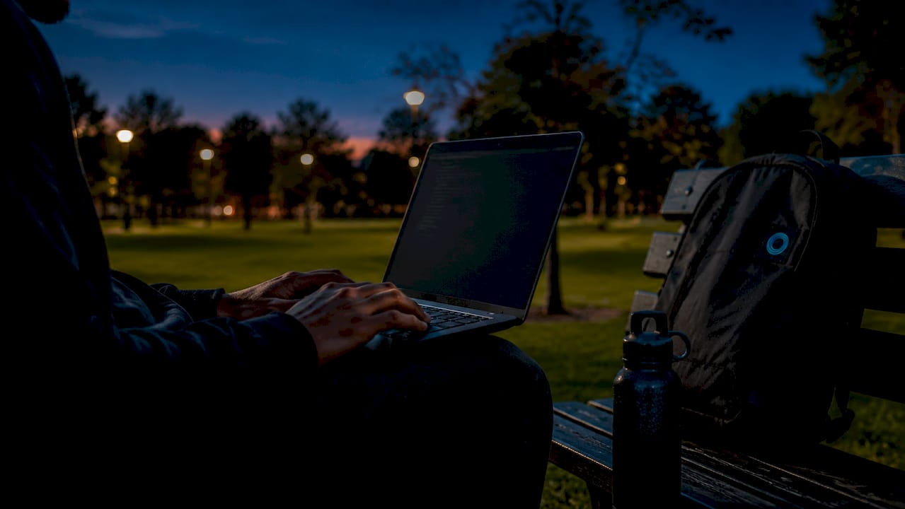 Close-up of hands typing markdown code on laptop