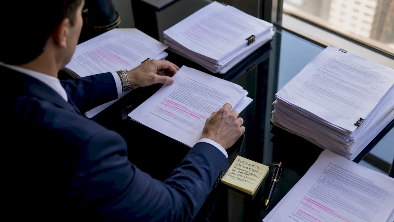 Auditor hands sorting regulatory documents