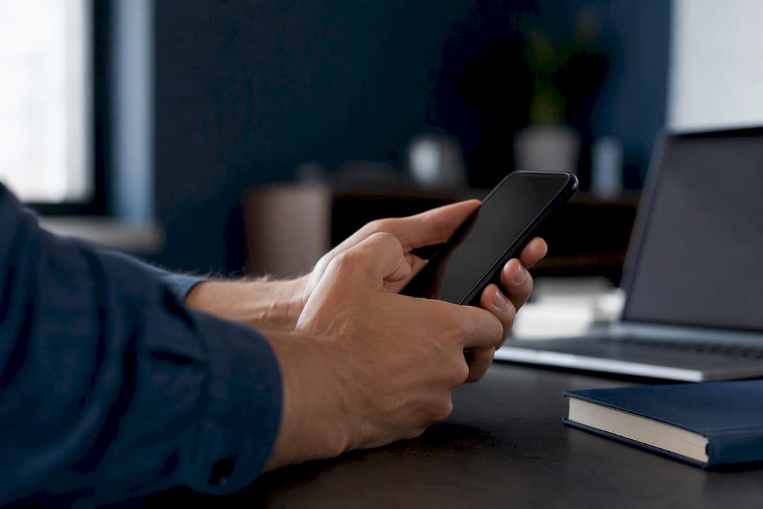 Hands adjusting email filters on smartphone