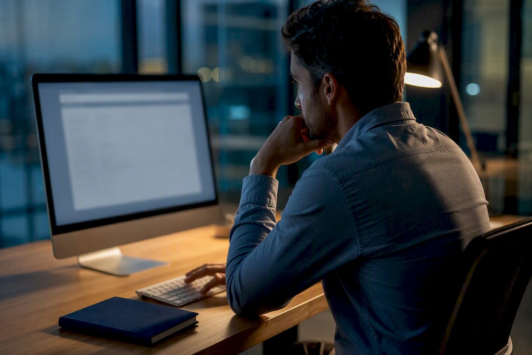 Professional pausing before sending work email