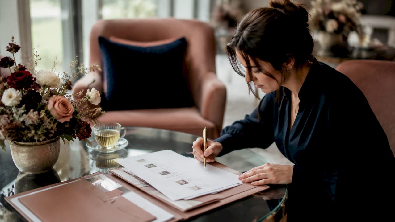 Wedding coordinator reviewing timeline in bridal suite