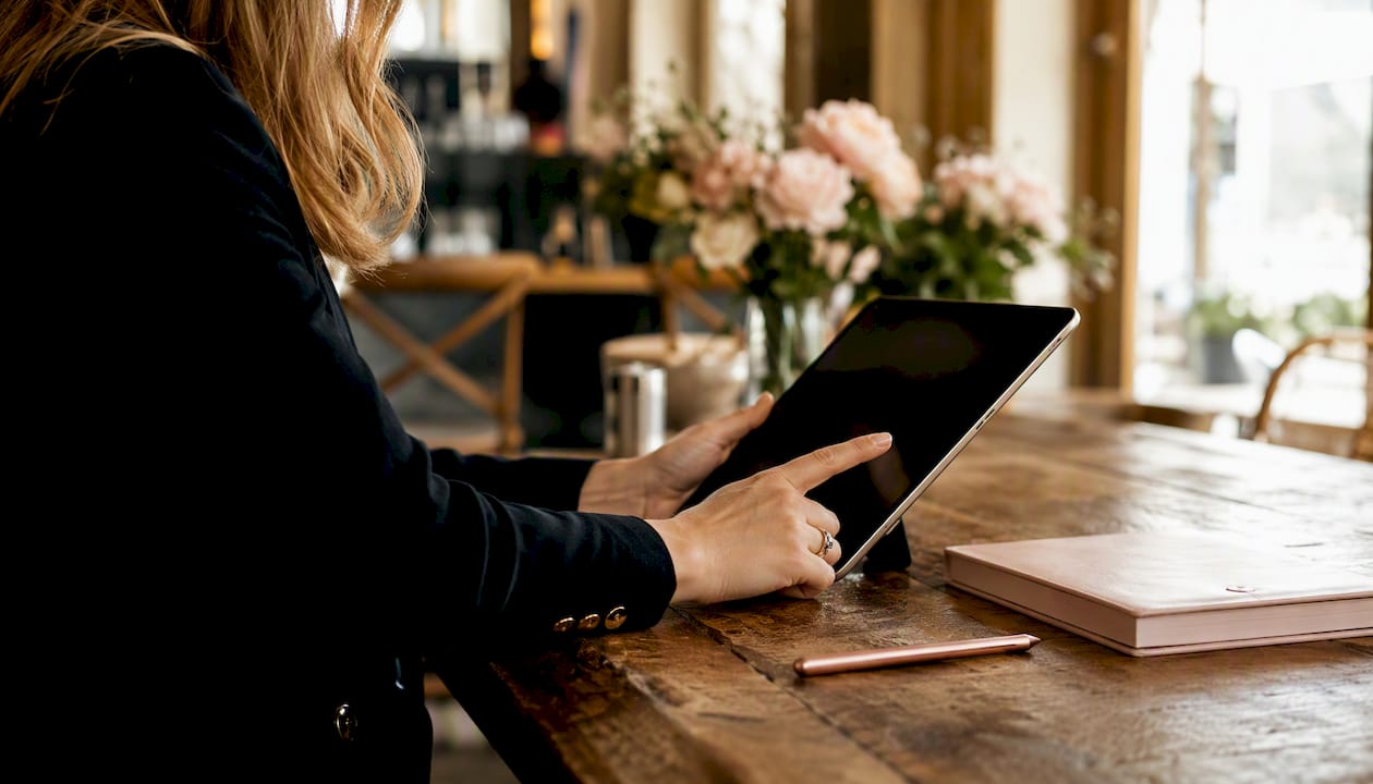 Planner hands managing intake form on tablet