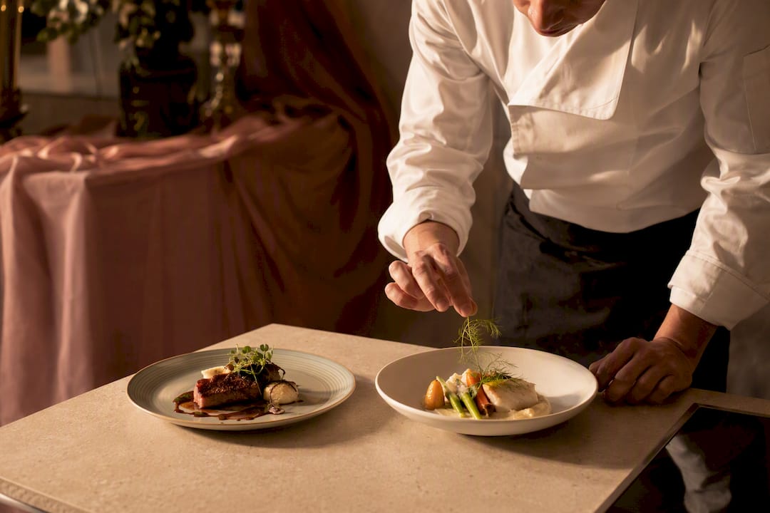Chef preparing allergy-safe and standard wedding meals