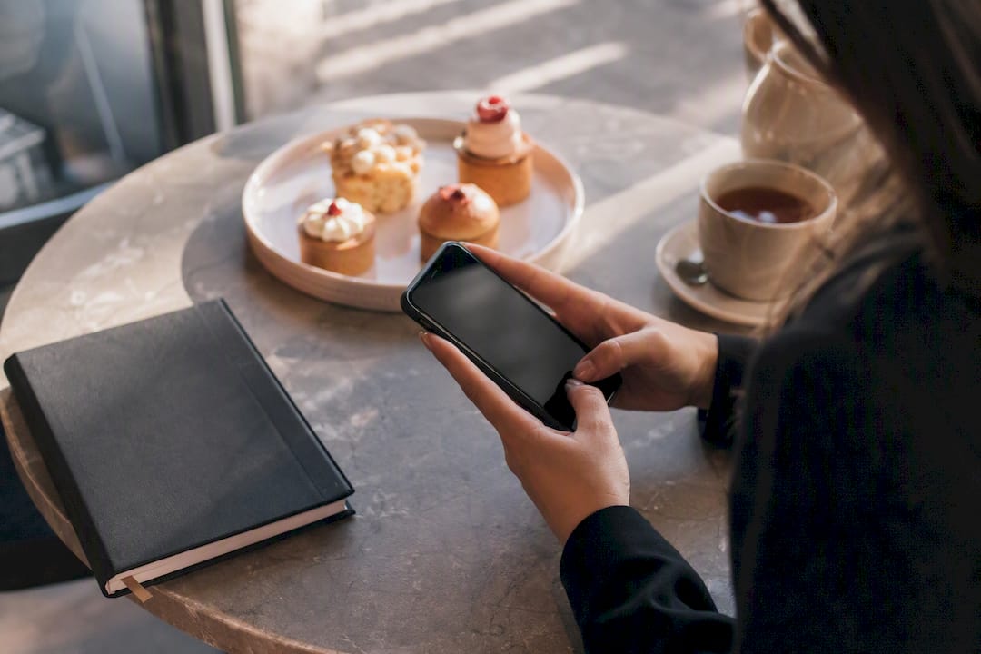 Hands sending SMS RSVP on smartphone