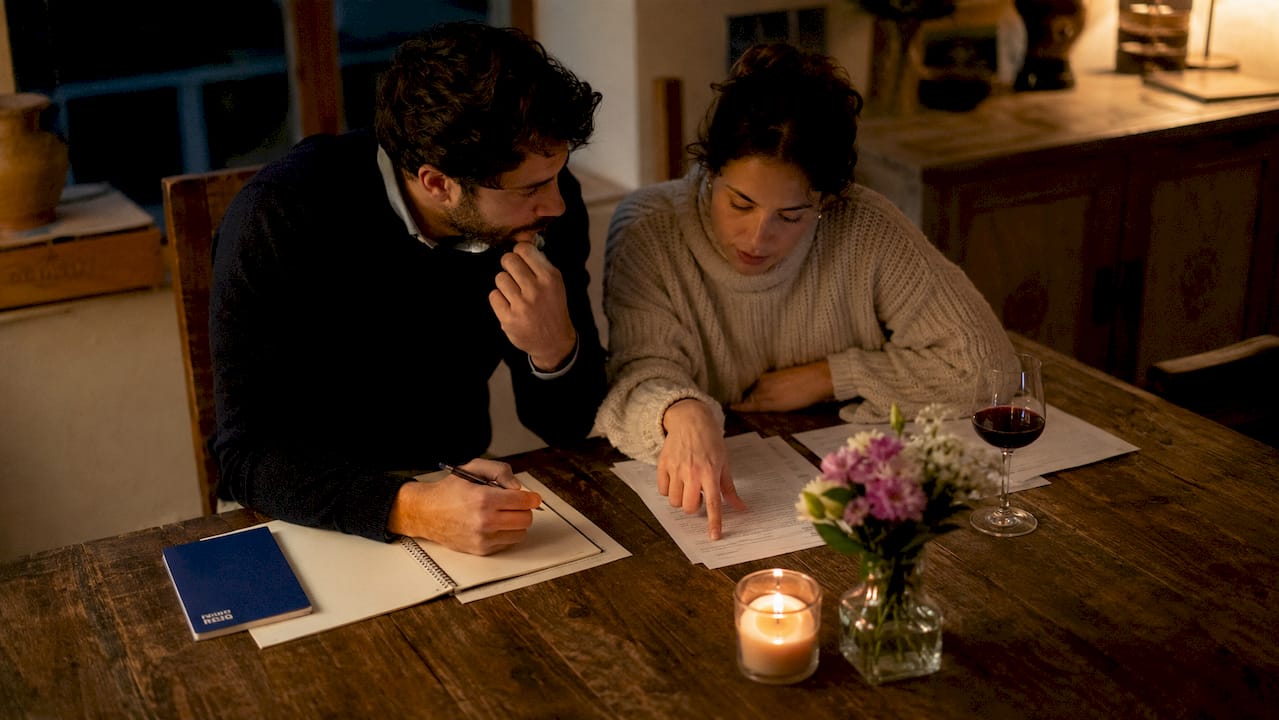 Spanish couple discussing property agreements