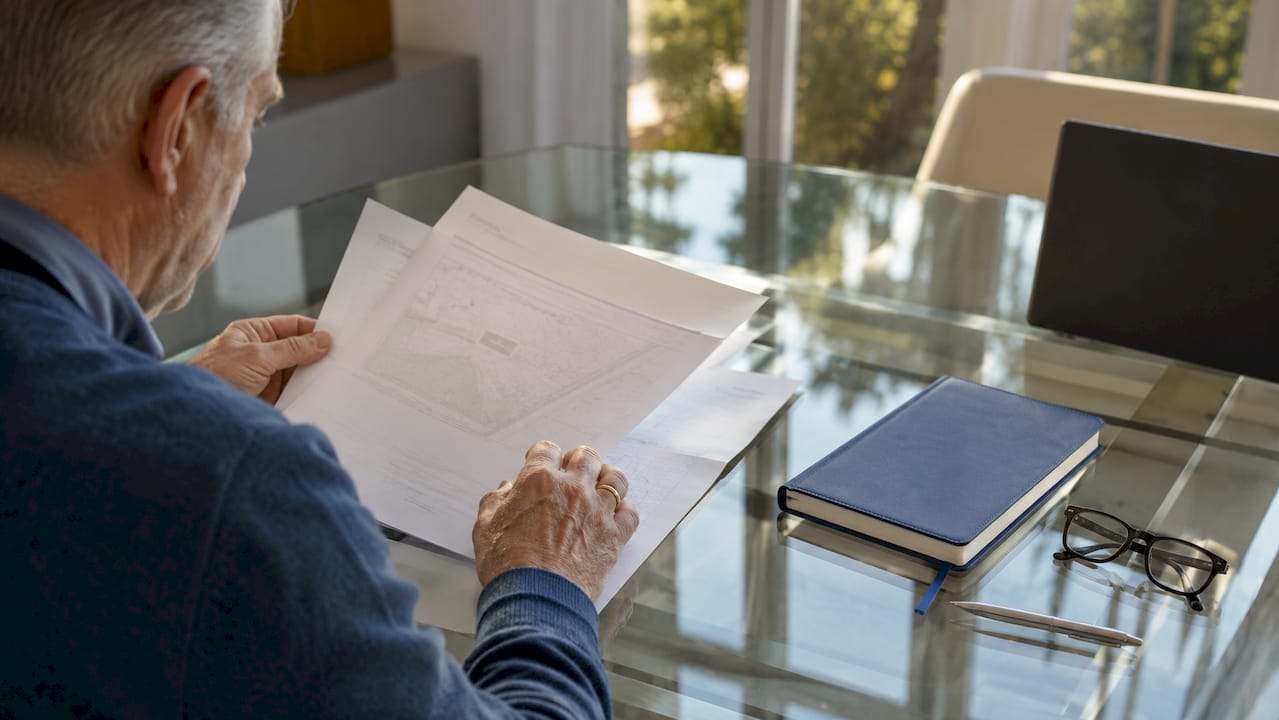 Hands holding official property registration papers