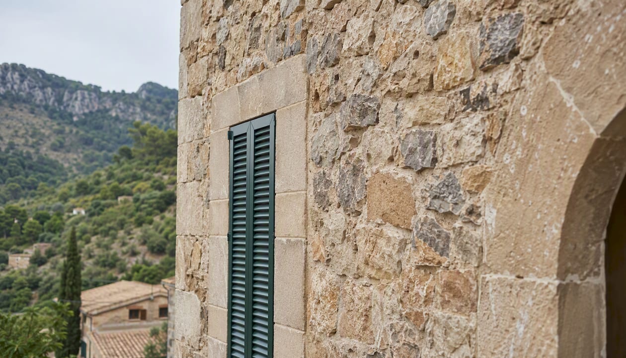 Stone facade restoration detail in Deià