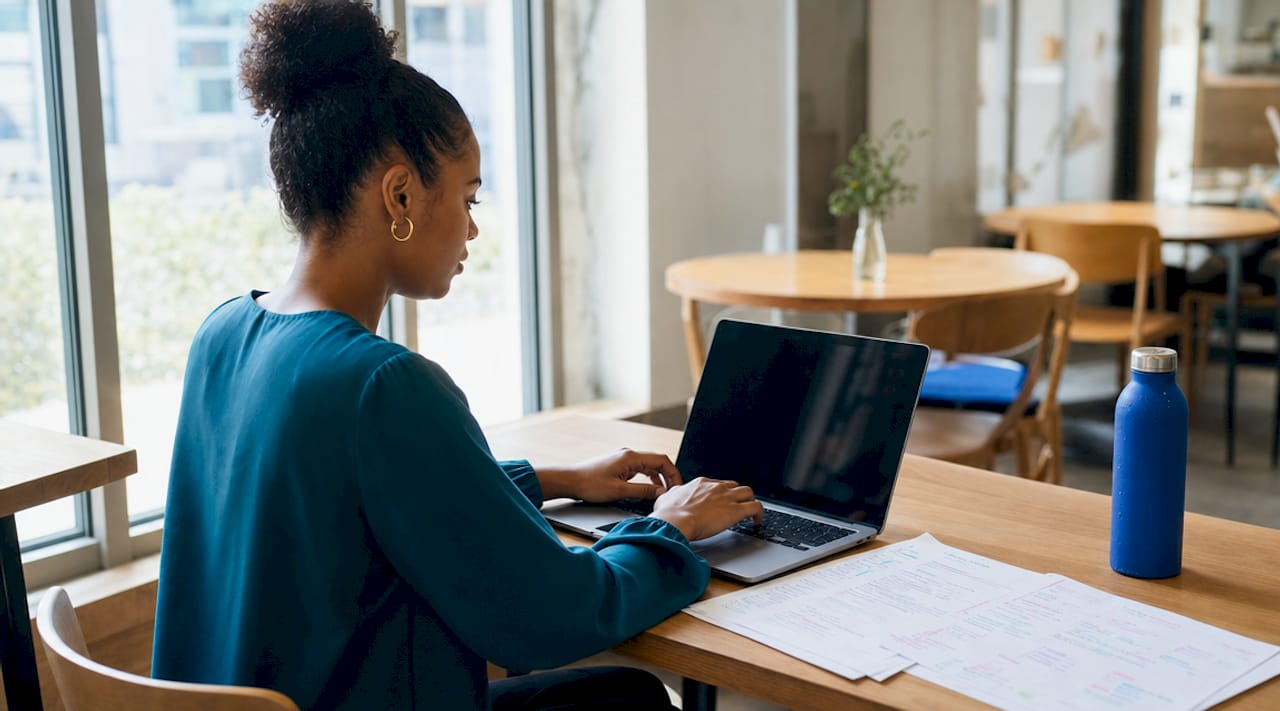Hands typing with transcript papers in coworking space
