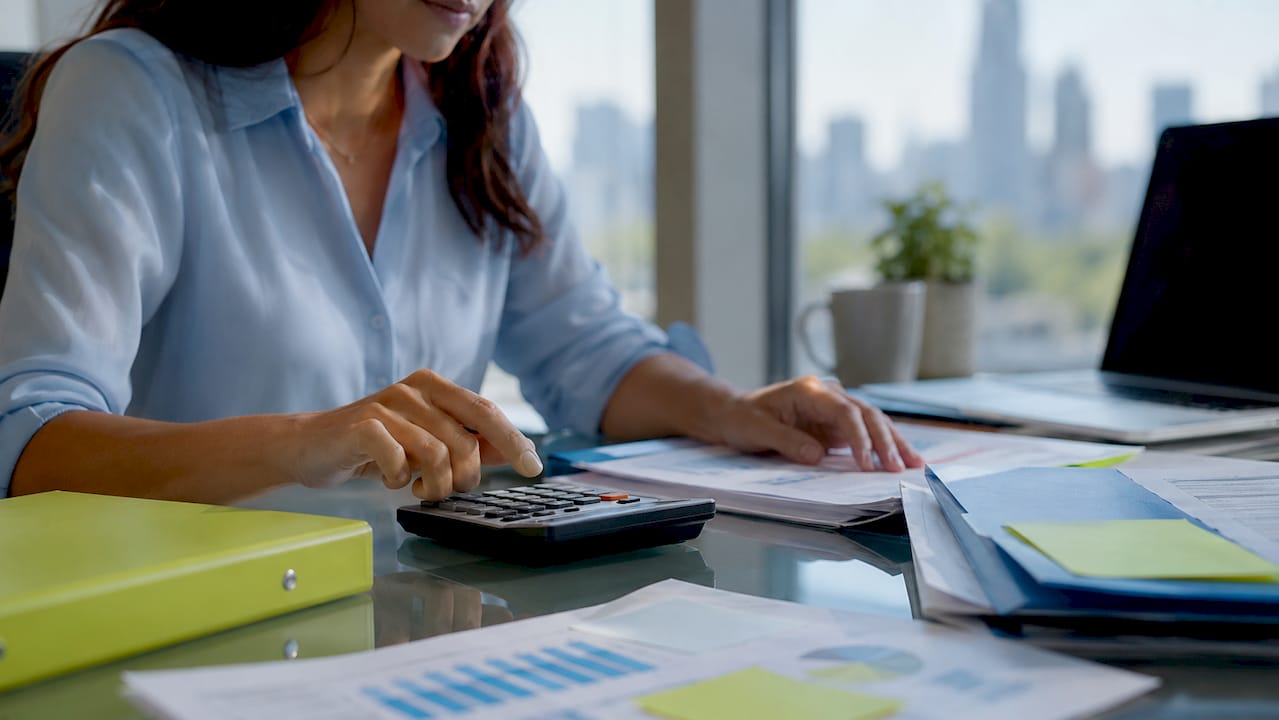 Hands calculating mortgage fees on desk