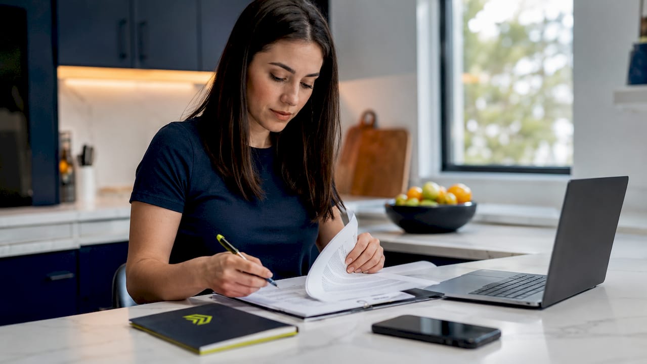 Hands sorting mortgage documents in home office