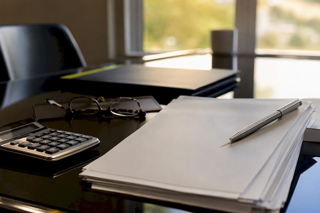 Close-up of real estate closing documents on table