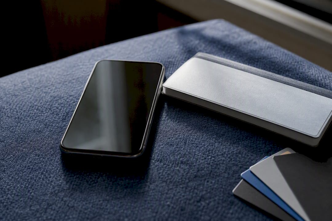 Smartphone and checkbook on table