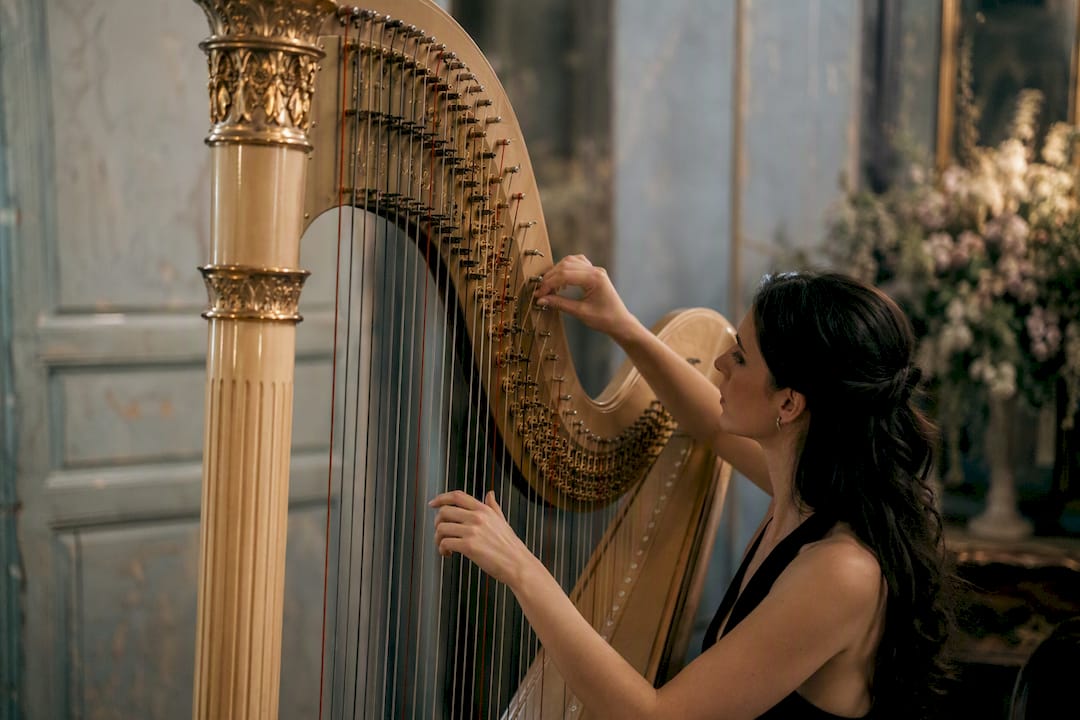 Harpist tuning harp backstage