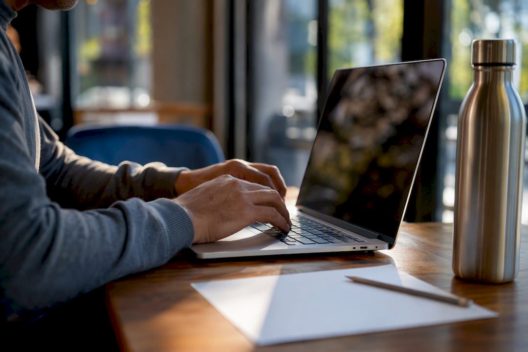 Broker’s hands over laptop keyboard