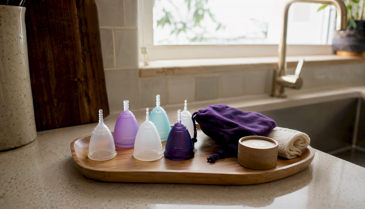Various menstrual cup types displayed on bathroom counter